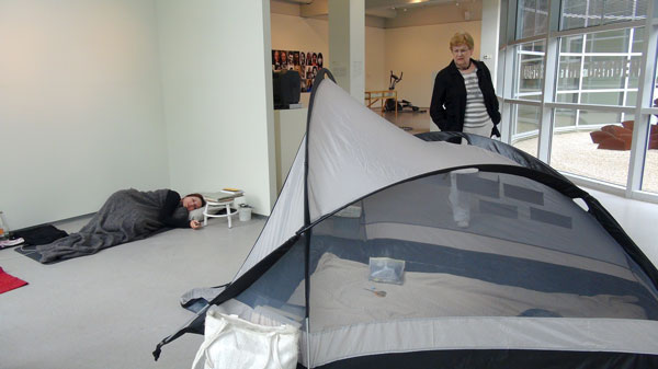 artist sleeping in museum